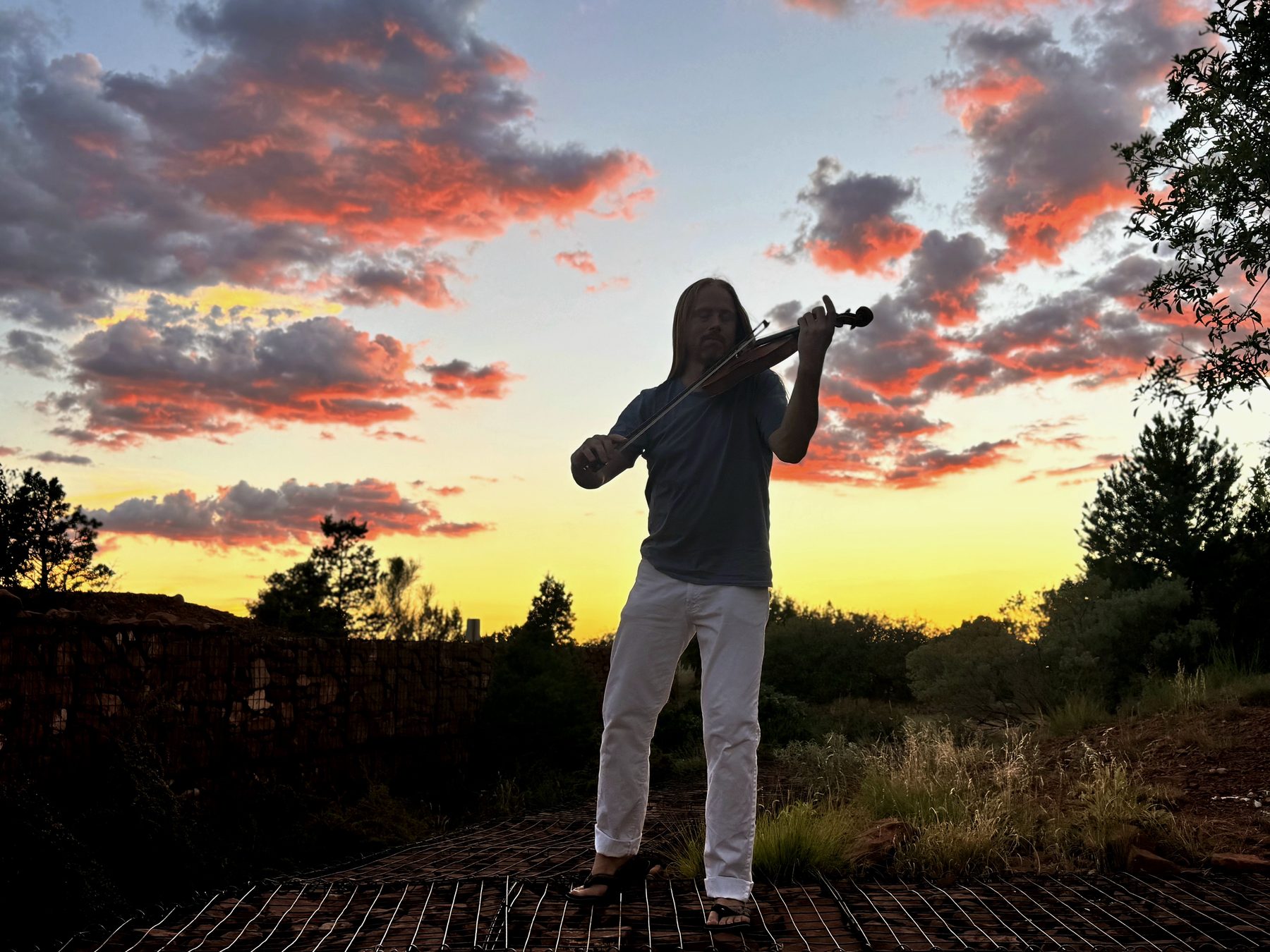Tyler Carson playing violin at Sedona sunset